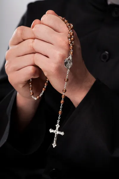 Priest is holding rosary — Stock Photo, Image