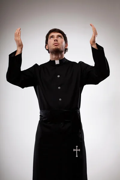 Priest raising hands and praying — Stock Photo, Image