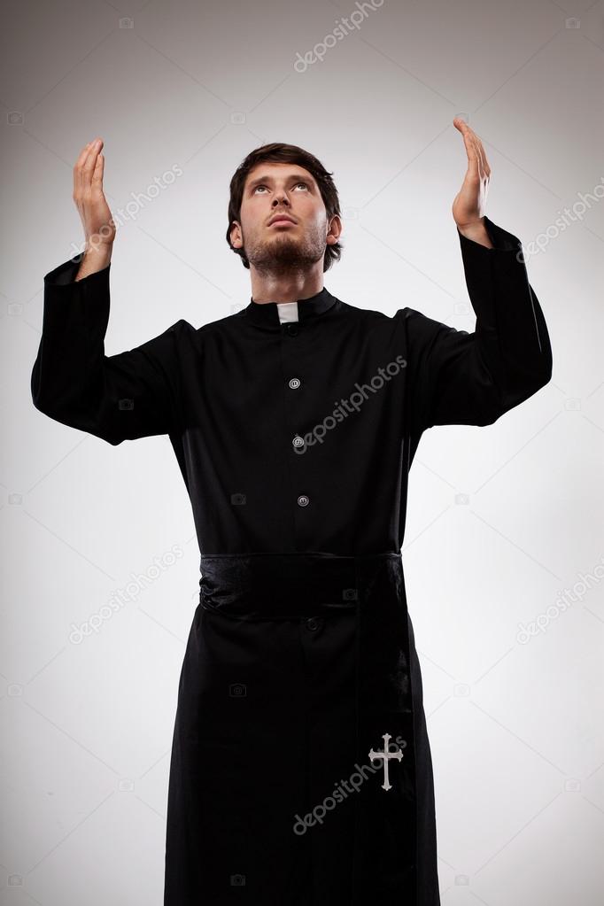 Priest raising hands and praying