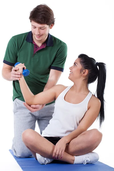 Working on biceps with a trainer — Stock Photo, Image