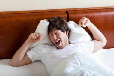 Yawning man after awakening clipart