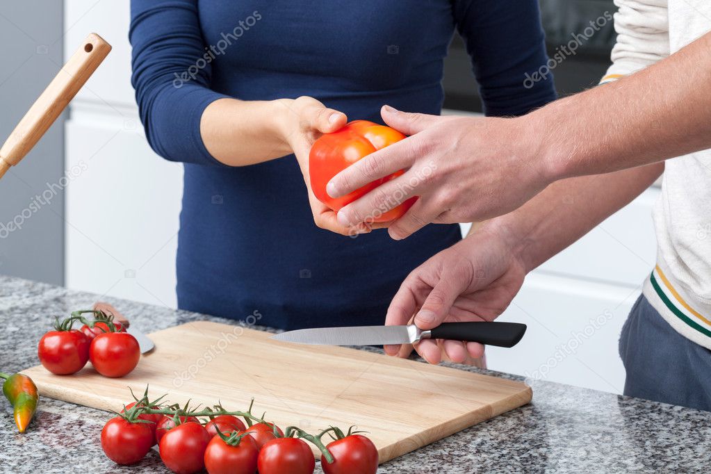 Couple cutting vegatables