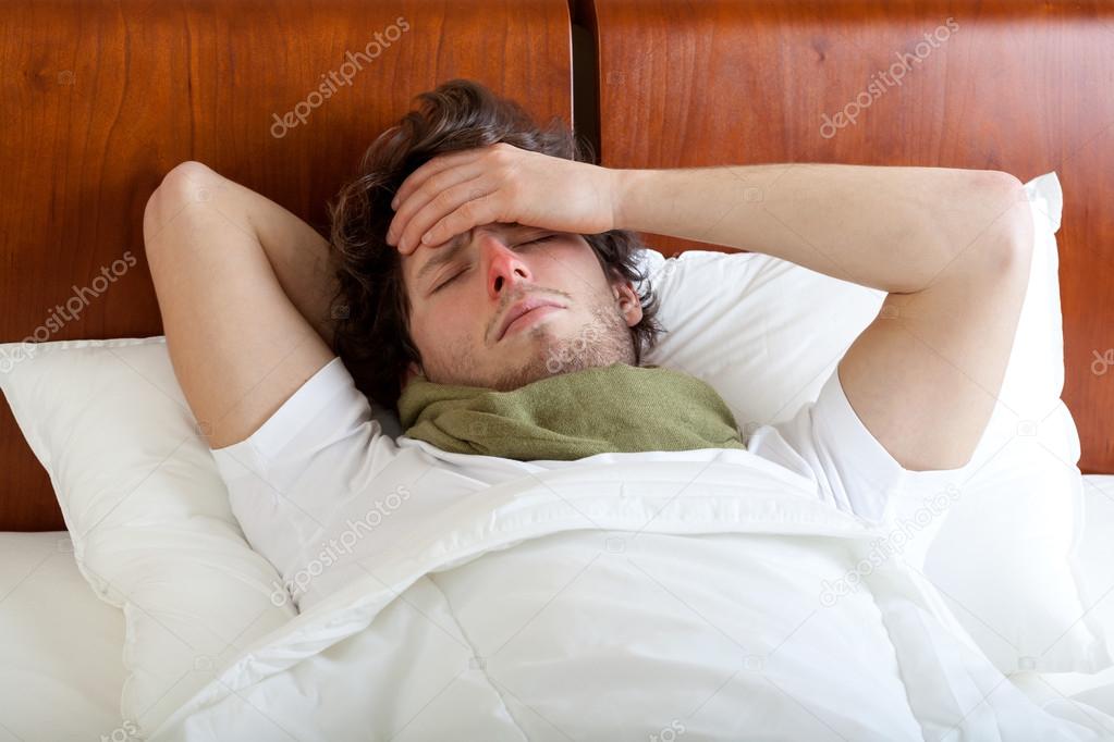 Man having cold in bed
