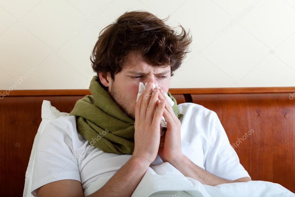 Man with running nose in bed
