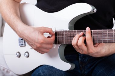 oturan adam gitar çalmak