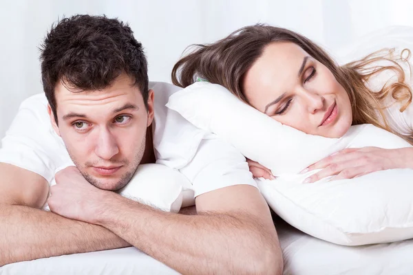 Sleeping wife and thoughtful husband — Stock Photo, Image