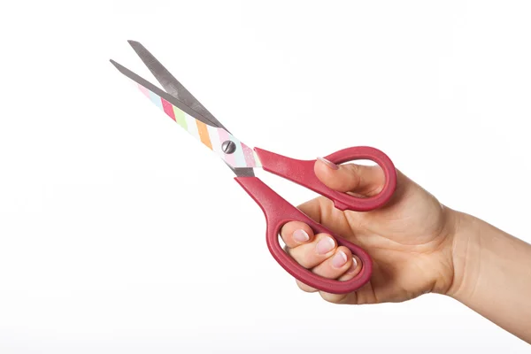 Рука с разноцветными ножницами — стоковое фото