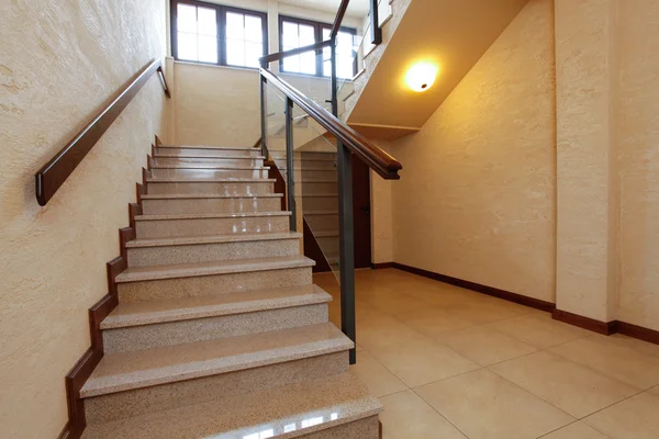 Modern stone stairs with wooden banister — Stock Photo, Image