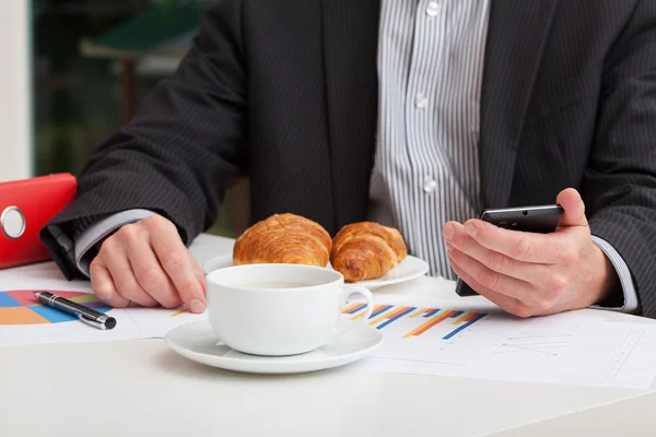Coffee and croissant at work — Stock Photo, Image