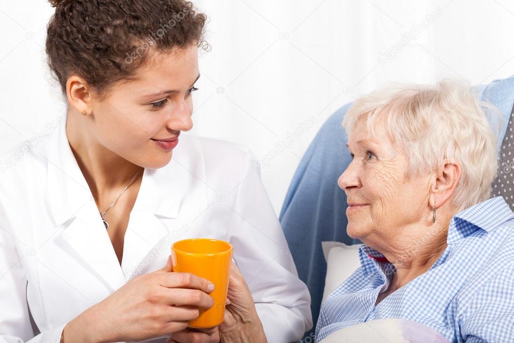 Nurse taking care of elderly woman