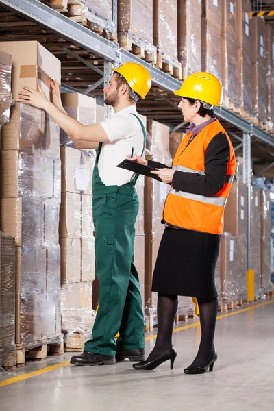 Superior and worker in warehouse — Stock Photo, Image