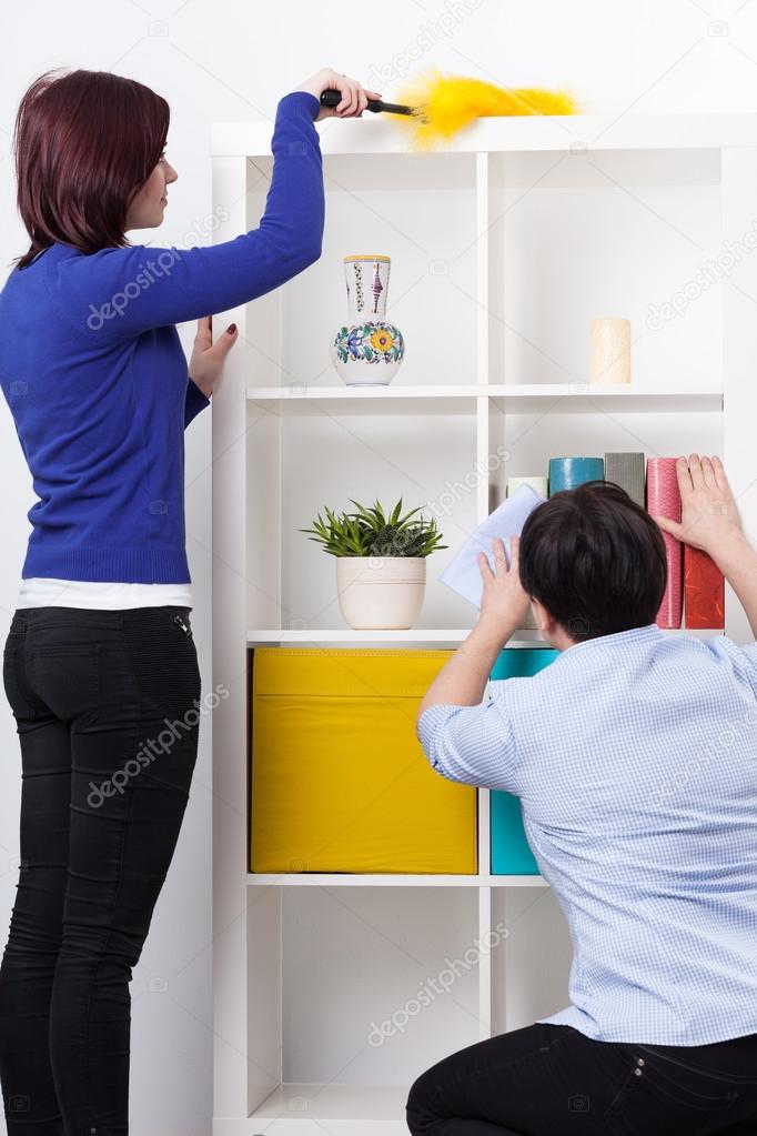 Daughter and mother during dusting