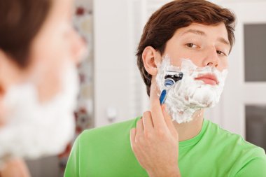 Man shaving in bathroom clipart