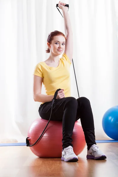 Woman practising at fitness room — Stock Photo, Image