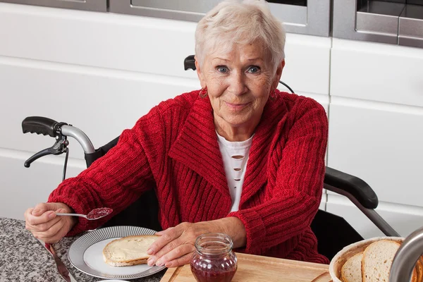 Disabled elderly in kitchen — Stock Photo, Image