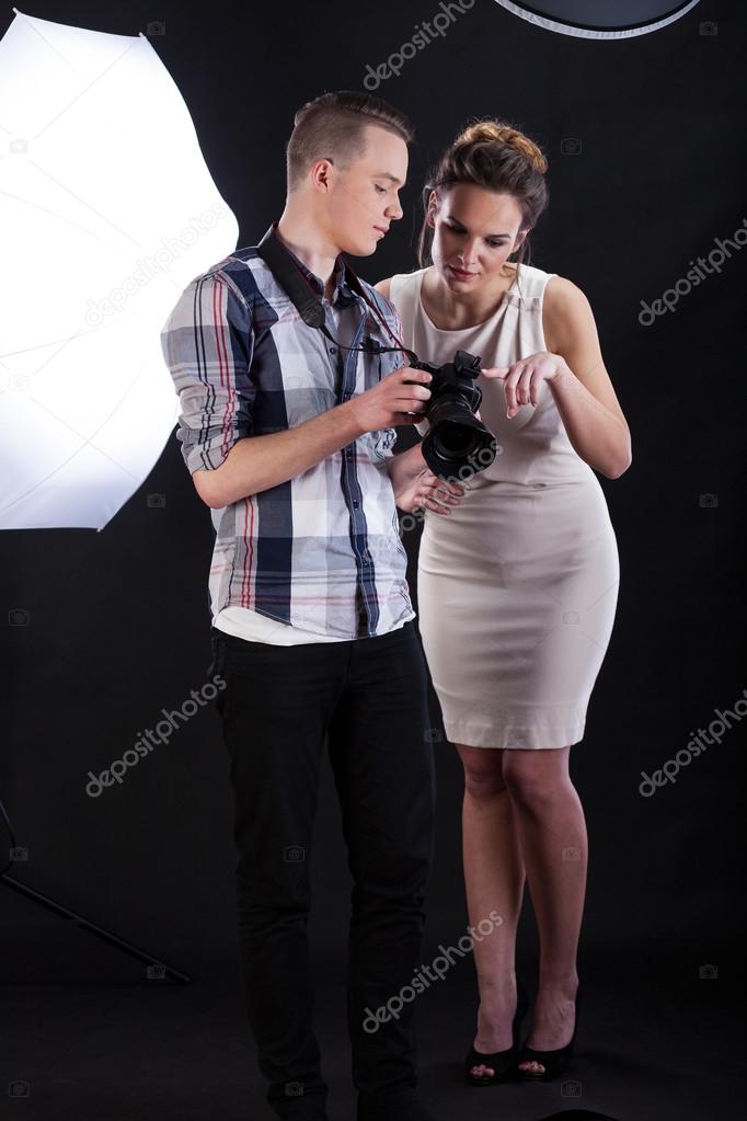 Model and photographer analysing a photo