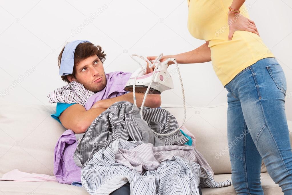 Man and woman ironing