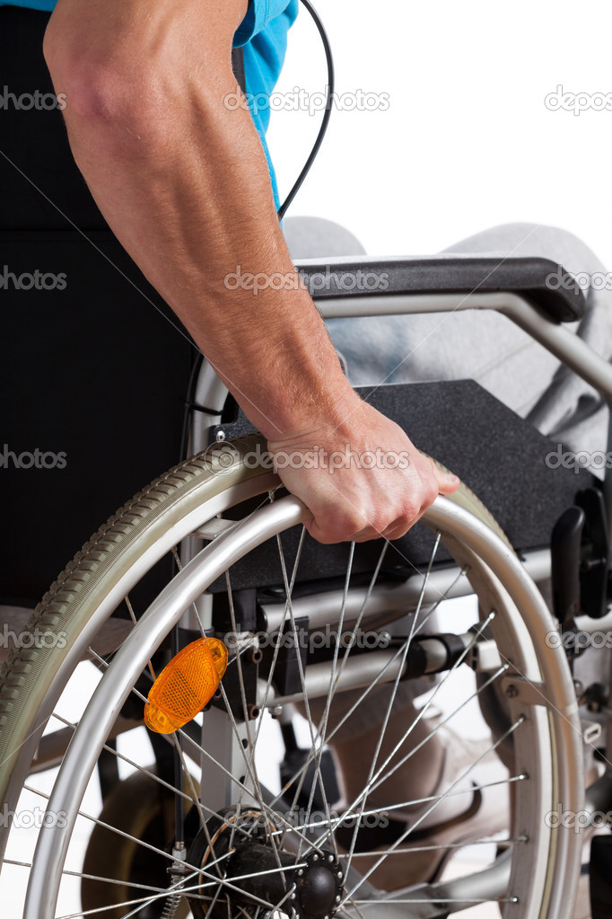 Man propelling wheelchair