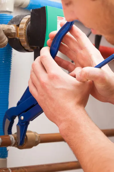 Repairman with pipe wrench — Stock Photo, Image