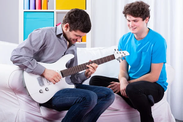 Freunde spielen E-Gitarre — Stockfoto