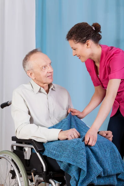 Nurse caring about disabled man — Stock Photo, Image