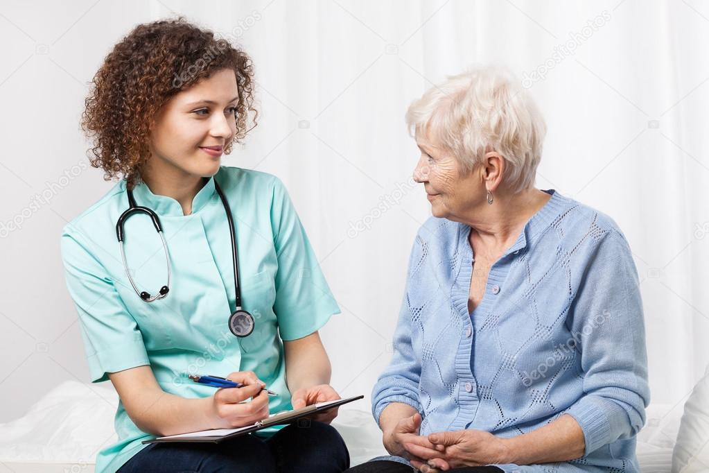 Doctor examining elderly woman