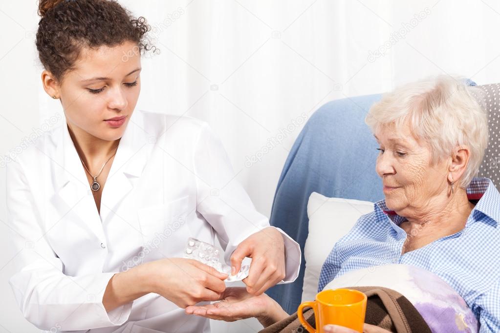 Nurse giving woman vitamin