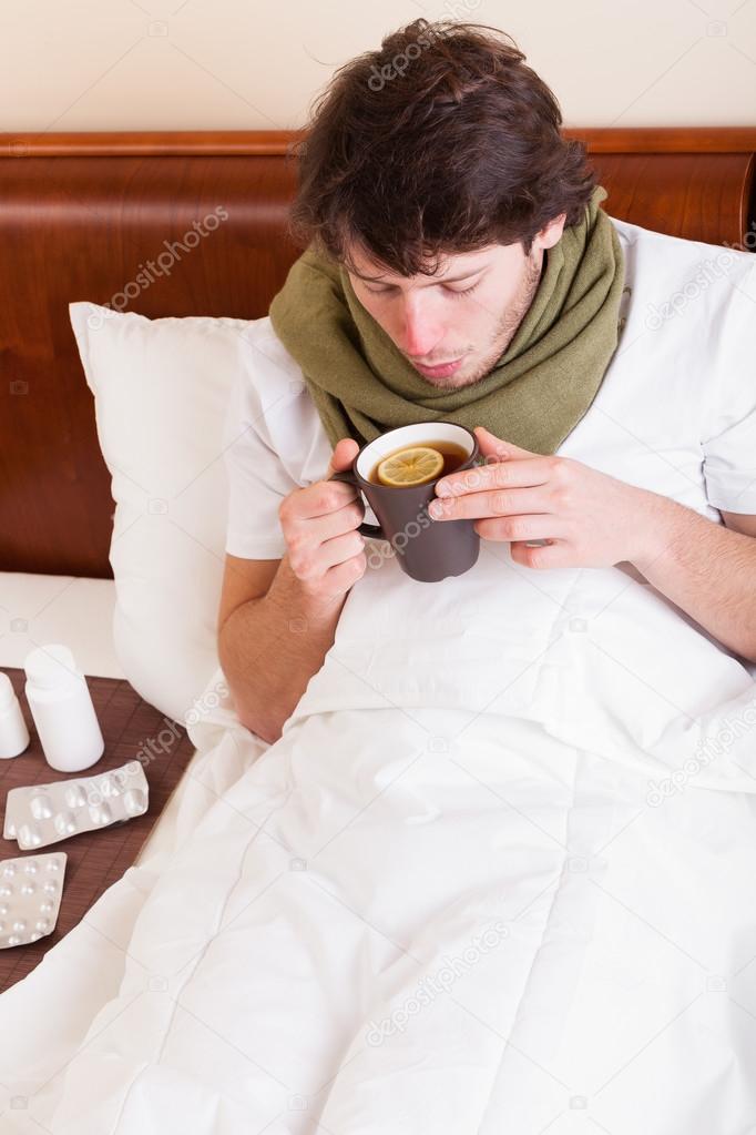 Sick man drinking tea