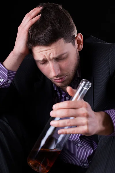 Drunk businessman with bottle of wine — Stock Photo, Image