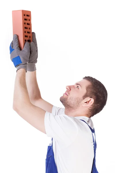 Bricklayer giving a brick — Stock Photo, Image