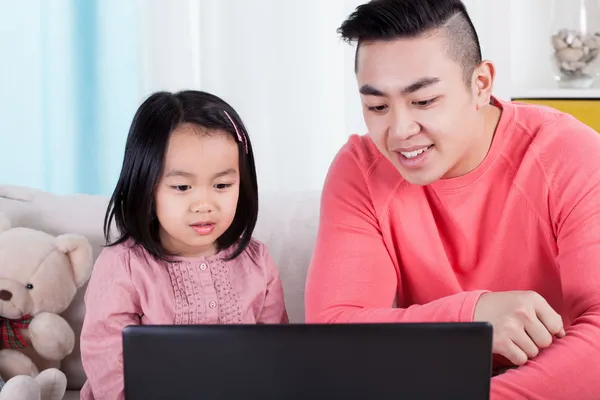 Family playing on computer — Stock Photo, Image
