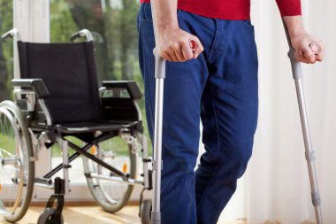 Disabled man on crutches
