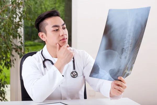 Asian doctor analysing X-ray — Stock Photo, Image