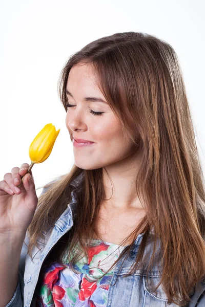 Attractive woman smelling spring tulip — Stock Photo, Image