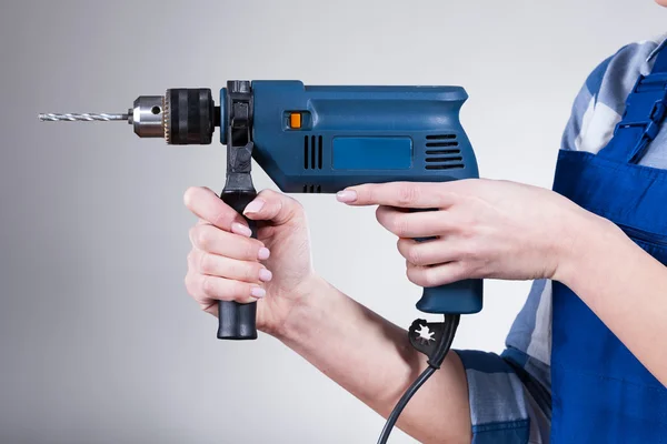 Woman holding a drill — Stock Photo, Image