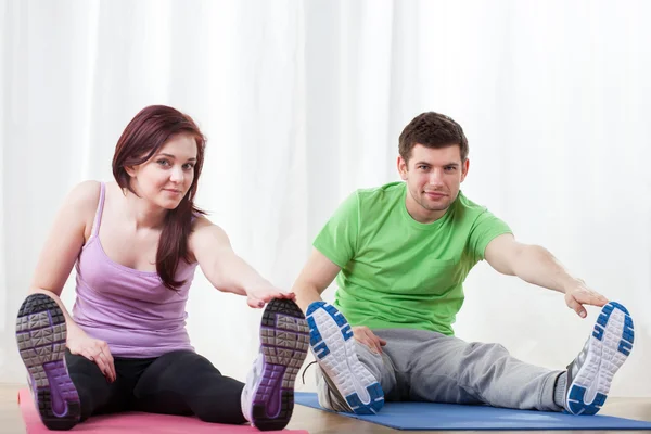 Woman and man stretching — Stock Photo, Image