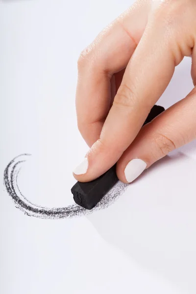 Woman paints something black pastel — Stock Photo, Image