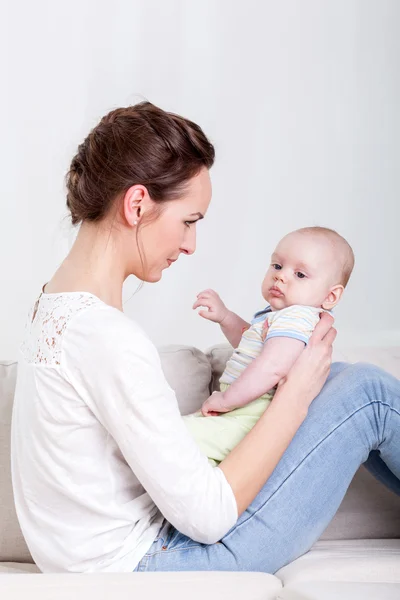 Mother and baby on a sofa — Stock Photo, Image