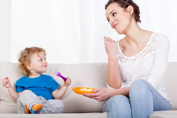 Мама і дитина їдять їжу разом — стокове фото