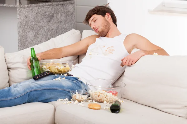 Wasted man surrounded by mess — Stock Photo, Image