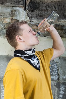 Young boy drinking vodka clipart