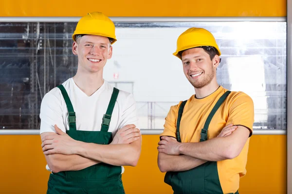 Workers in protective workwear standing with arms crossed — Stock Photo, Image