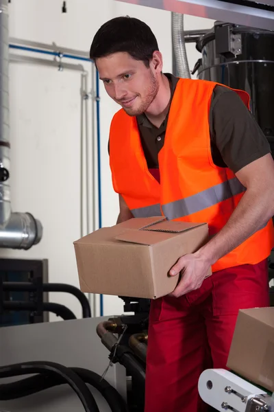 Blue-collar worker holding box — Stock Photo, Image
