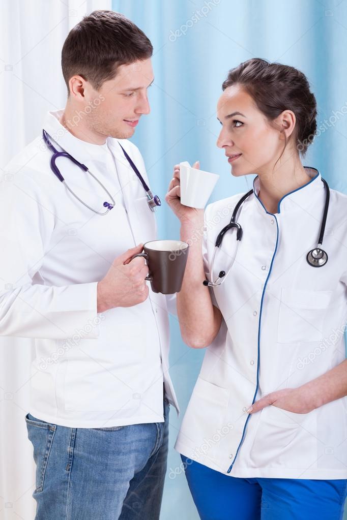 Young doctors drink coffee and talk 