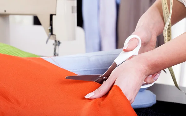 Tailor Cutting Fabric with Scissors — стоковое фото