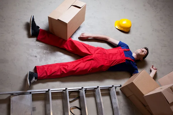 Storekeeper lying on floor — Stock Photo, Image