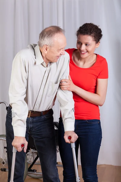 Woman helping a disabled — Stock Photo, Image