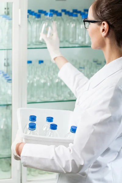 Glass bottles into cabinet — Stock Photo, Image