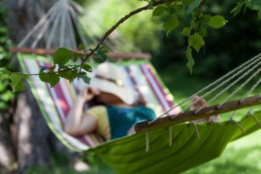 Woman sleeping on a hammock clipart