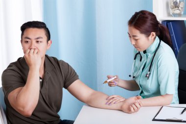 Asian nurse giving vaccination injection to patient clipart